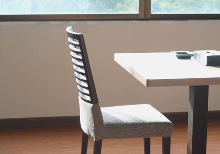 Wooden table and chairs in sunlight morning