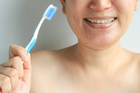 Woman holding toothbrush in hand, health conceptの写真素材