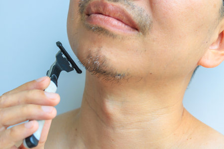 Man holding a regular razor, health conceptの写真素材