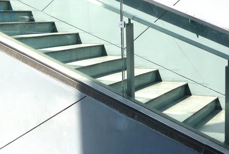 Concrete stairs with iron railings with glass partitionsの写真素材