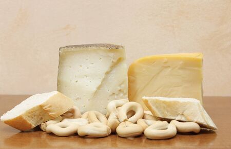 Still life with several types of cheese and slices of breadの写真素材