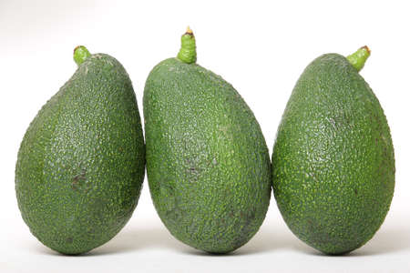 Three green avocado on a white background in which you can see the texture of your skinの写真素材