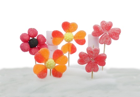 flowers made  with different types of candy on a background of sweet cottonの写真素材