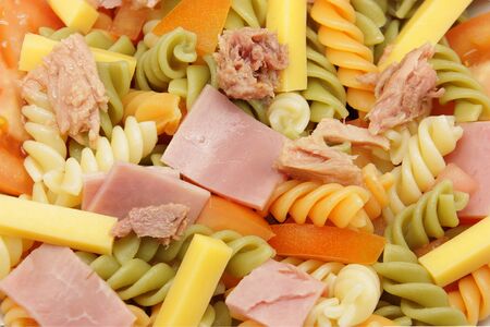 Close up of a vegetable pasta salad, ham, tuna and cheeseの写真素材