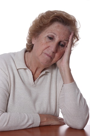 Portrait of a sad elderly woman on a white backgroundの写真素材