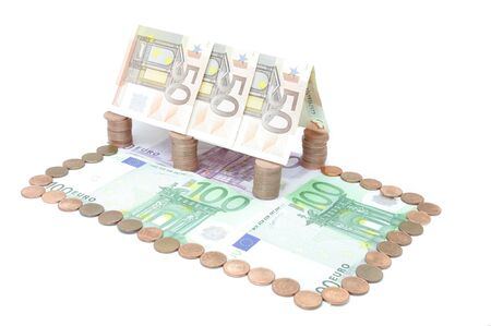 House made of coins and banknotes symbolizing the value of real estateの写真素材