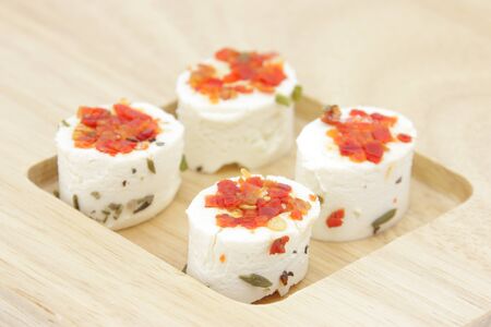 Appetizer consisting of small portions of fresh artisan cheeses flavored with spices.の写真素材