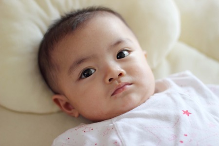 Beautiful baby smiling looking at cameraの写真素材