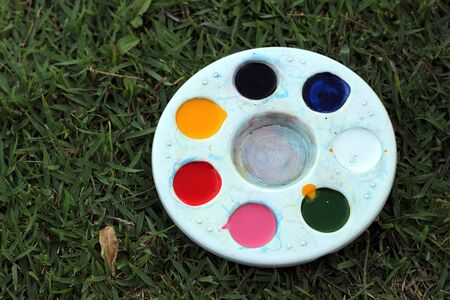 artist paints a picture of oil paint brush in hand with paletteの写真素材