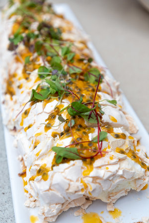 Meringue Pavlova cake with passion fruit and mint.の写真素材