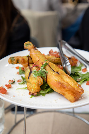 Fried chicken wings on a white plate with salad.の写真素材