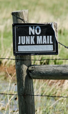 Metal sign on wooden fence warning no junk mailの写真素材