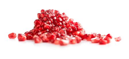 heap of ripe pomegranate seeds isolated on white backgroundの写真素材