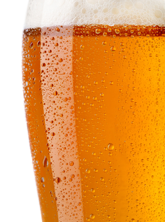 close-up view of glass of beer with big droplets and foamの写真素材