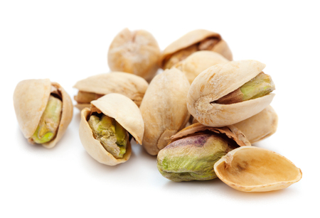 heap of ripe pistachios isolated on white backgroundの写真素材