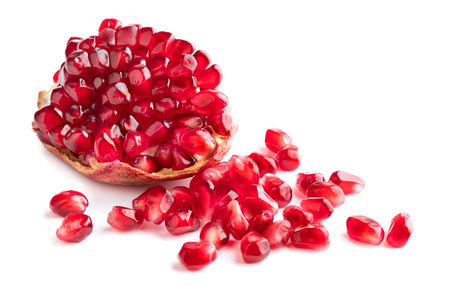 piece of red ripe pomegranate with lot of seeds isolated on white backgroundの写真素材