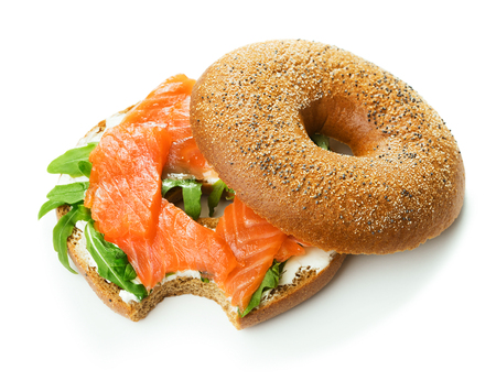 single fresh bagel sandwich with salmon, arugula and cream cheese isolated on white backgroundの写真素材