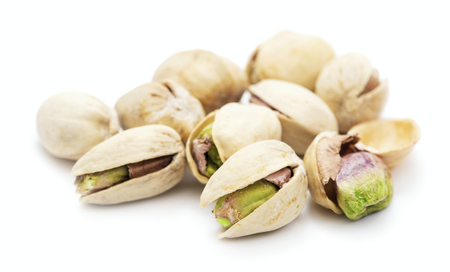 heap of ripe pistachios isolated on white backgroundの写真素材