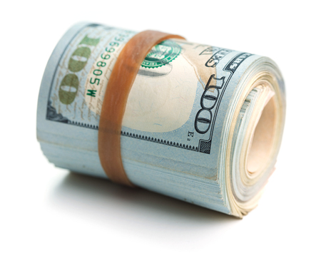 rolled stack of hundred dollars notes isolated on white backgroundの写真素材