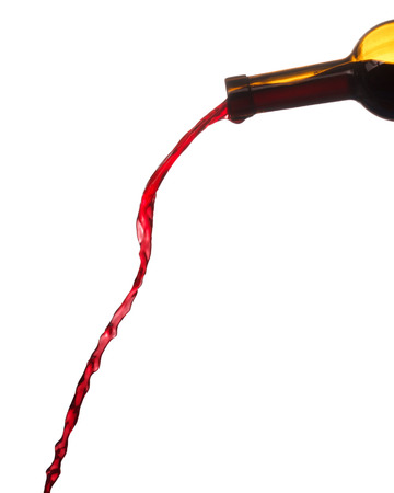 single red wine splash from bottle isolated on white backgroundの写真素材