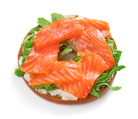 single fresh bagel sandwich with salmon, arugula and cream cheese isolated on white backgroundの写真素材