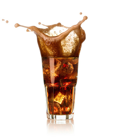 glass of cola with splash and drops isolated on white backgroundの写真素材