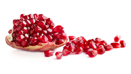 piece of red ripe pomegranate with lot of seeds isolated on white backgroundの写真素材