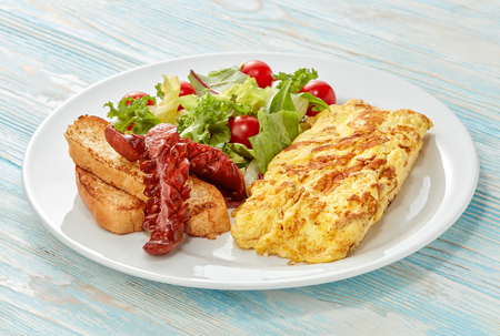 fresh breakfast with egg and vegetable in plate on blue wooden tableの写真素材