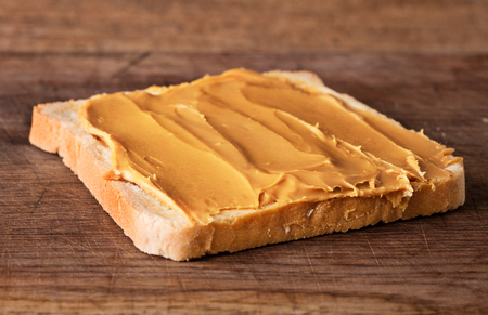 close-up view of peanut butter sandwich on wooden backgroundの写真素材