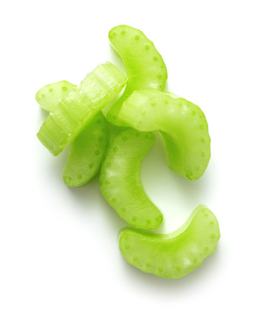 heap of fresh chopped celery stick isolated on white backgroundの写真素材