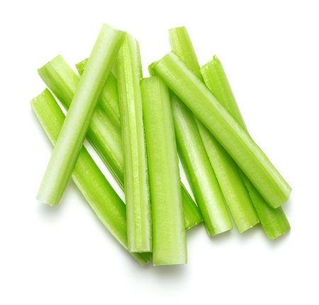 heap of fresh chopped celery stick isolated on white backgroundの写真素材