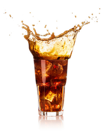 glass of cola with splash and drops isolated on white backgroundの写真素材