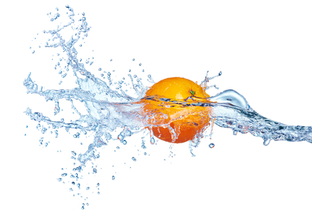 single orange fruit in blue water splashの写真素材