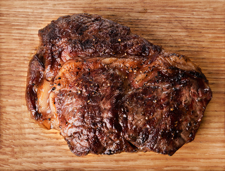 close-up view of grilled beef steak on wooden backgroundの写真素材