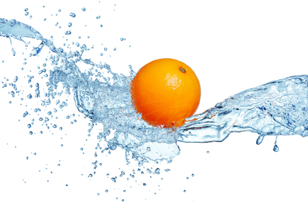 single orange fruit in blue water splashの写真素材