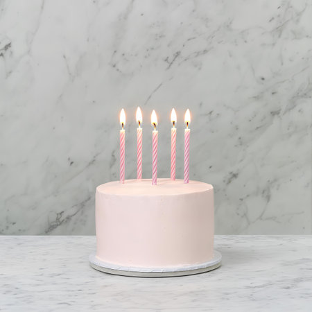 Pink birthday cake with five candles, marble background. Festive celebration. AI Generatedの素材