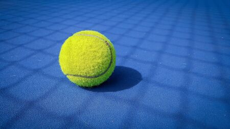 Close-up shots of tennis balls on a blue background fieldの写真素材
