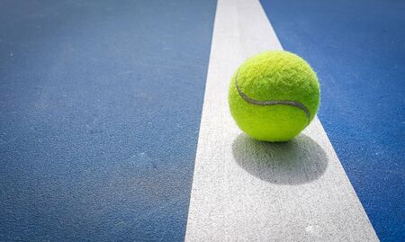 Close-up shots of tennis balls on a blue background fieldの写真素材