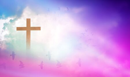 Christian cross appeared bright in the sky with soft fluffy clouds, white, beautiful colors. With the light shining as hope, love and freedom in the sky backgroundの写真素材