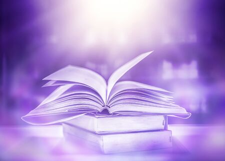 Stack of books in the library and blur bookshelf backgroundの写真素材