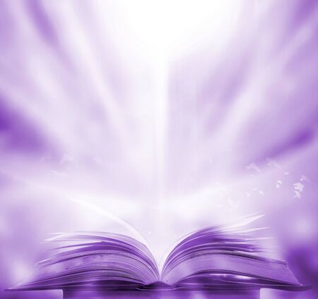 The blurred book that is bewitched with magic, the magic light in the dark, with the bright light shining down as the power to search for knowledge. For research and use as a blurred backgroundの写真素材