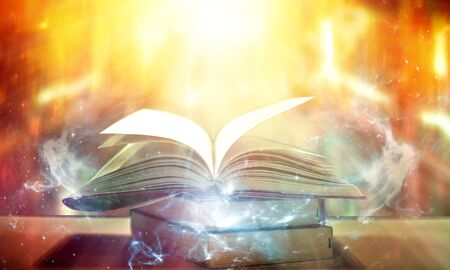 The blurred book that is bewitched with magic, the magic light in the dark, with the bright light shining down as the power to search for knowledge. For research and use as a blurred backgroundの写真素材