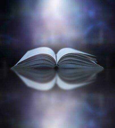 Stack of books in the library and blur bookshelf backgroundの写真素材