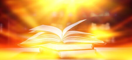 The blurred book that is bewitched with magic, the magic light in the dark, with the bright light shining down as the power to search for knowledge. For research and use as a blurred backgroundの写真素材