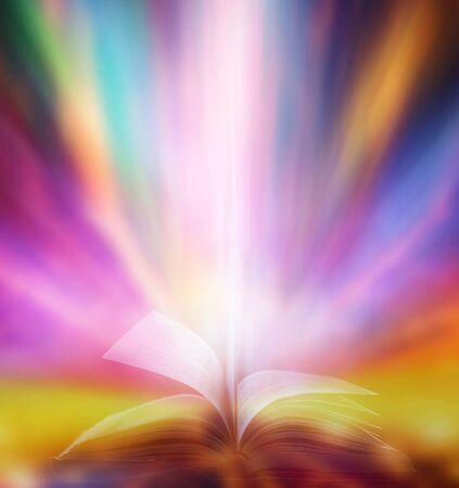 The blurred book that is bewitched with magic, the magic light in the dark, with the bright light shining down as the power to search for knowledge. For research and use as a blurred backgroundの写真素材