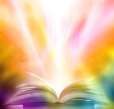 The blurred book that is bewitched with magic, the magic light in the dark, with the bright light shining down as the power to search for knowledge. For research and use as a blurred backgroundの写真素材