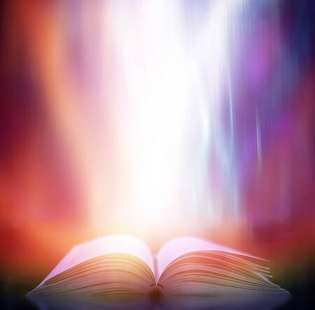 The blurred book that is bewitched with magic, the magic light in the dark, with the bright light shining down as the power to search for knowledge. For research and use as a blurred backgroundの写真素材