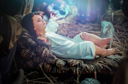 Traditional Christmas scenes and sacred light shining for use in illustration design Nativity scenes with Jesus baby on the manger with carvings, including Jesus, Mary, Joseph, sheep and magiの写真素材
