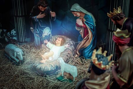Traditional Christmas scenes and sacred light shining for use in illustration design Nativity scenes with Jesus baby on the manger with carvings, including Jesus, Mary, Joseph, sheep and magiの写真素材