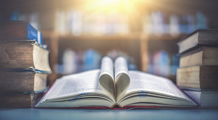 Stack of books in the library and blur bookshelf background